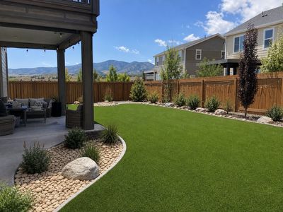 Aspirational Denver backyard with artificial turf, patio, and foothills view